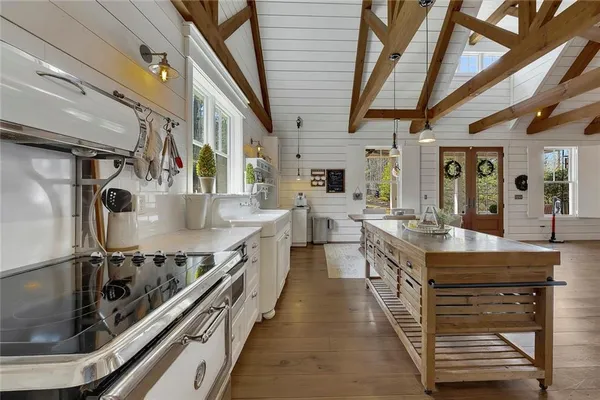 a large kitchen with stainless steel appliances granite countertop a stove and a sink