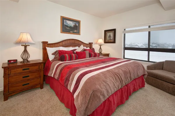 a bedroom with bed and a window