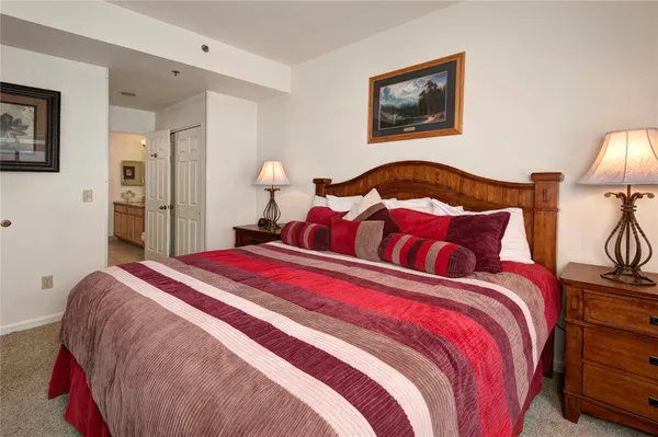 a bedroom with bed and a lamp