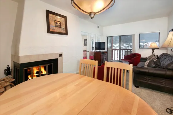a bedroom with furniture a flat screen tv and a fireplace