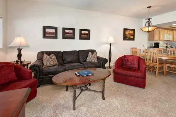 a living room with furniture a couch and a chandelier