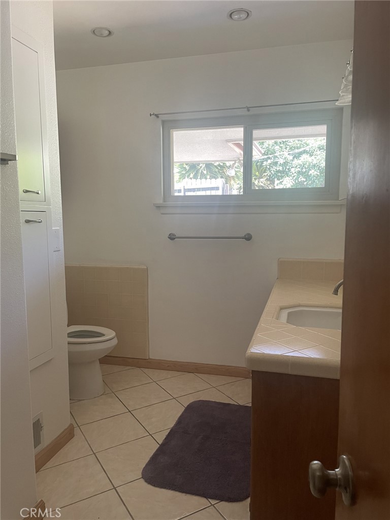 319 Tocino Drive Duarte, CA 91010 - Photo 16 of 23 a bathroom with a toilet a sink and a window