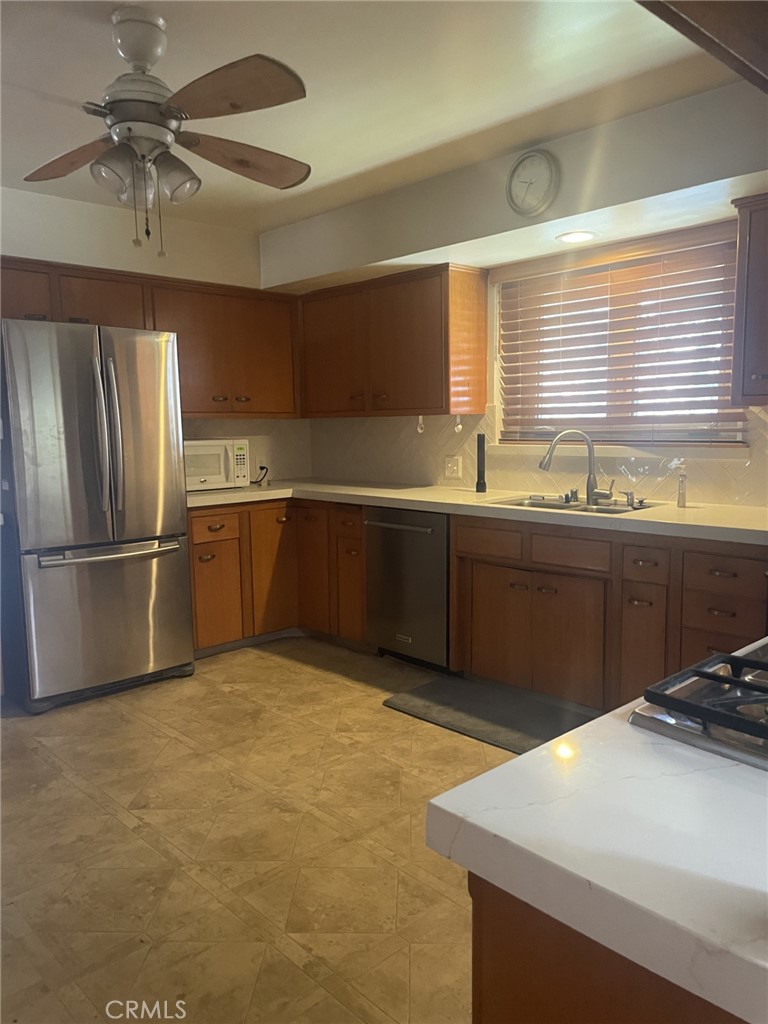 319 Tocino Drive Duarte, CA 91010 - Photo 7 of 23 a kitchen with stainless steel appliances granite countertop a sink and a refrigerator