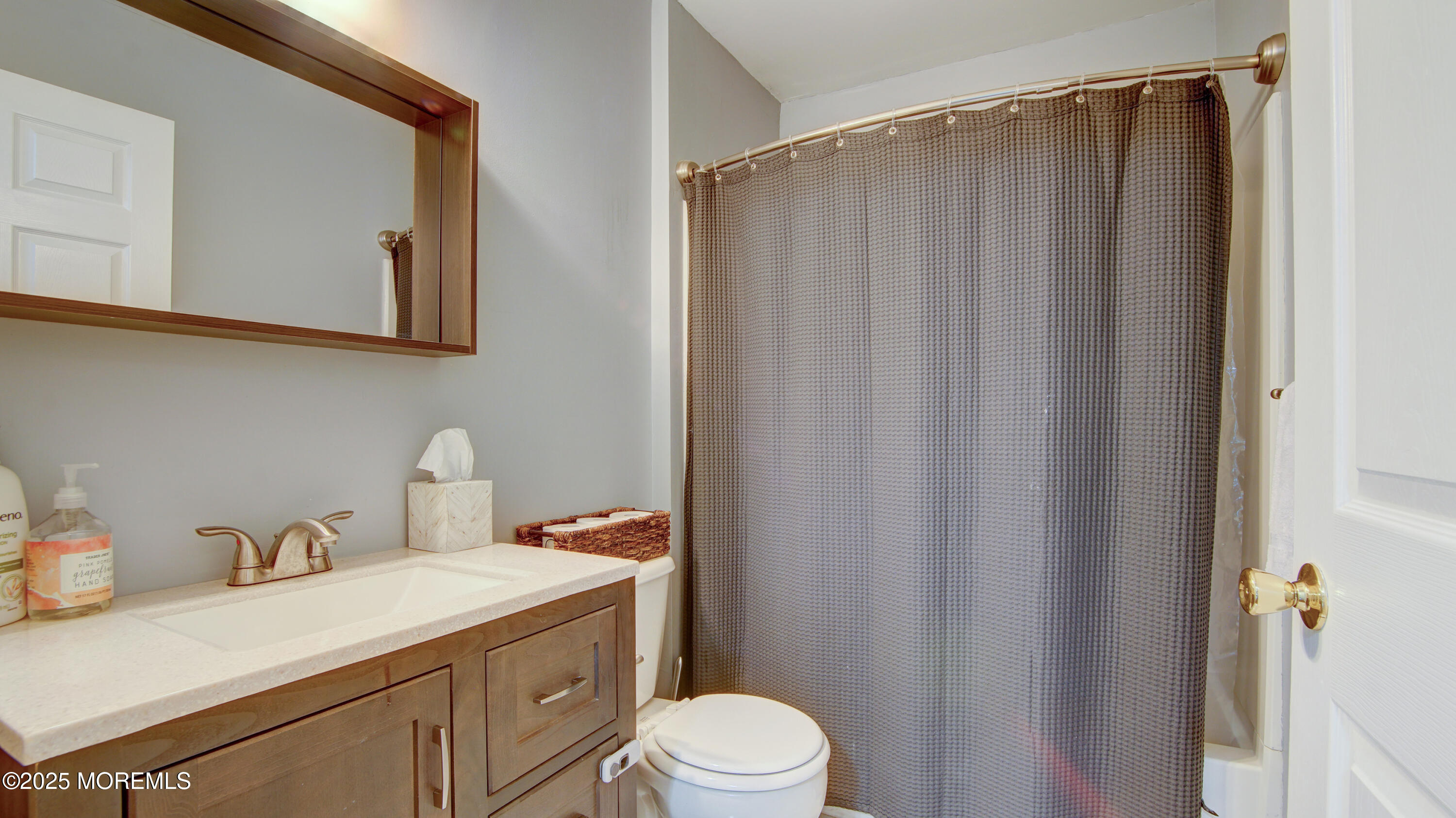 53 Winged Foot Court Howell, NJ 07731 - Photo 12 of 28 a bathroom with a sink a toilet and shower curtain