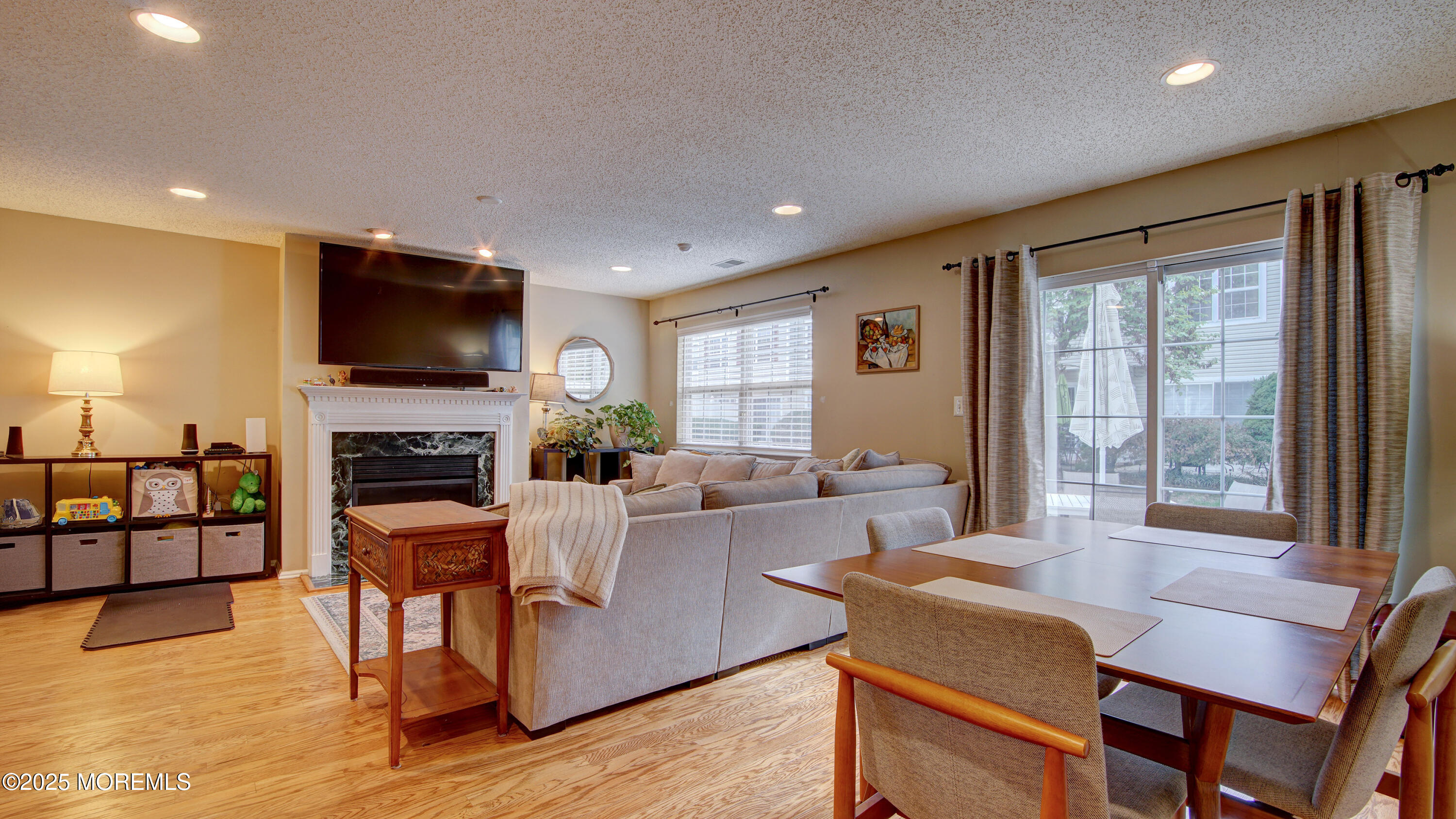 53 Winged Foot Court Howell, NJ 07731 - Photo 3 of 28 a living room with fireplace furniture and a flat screen tv
