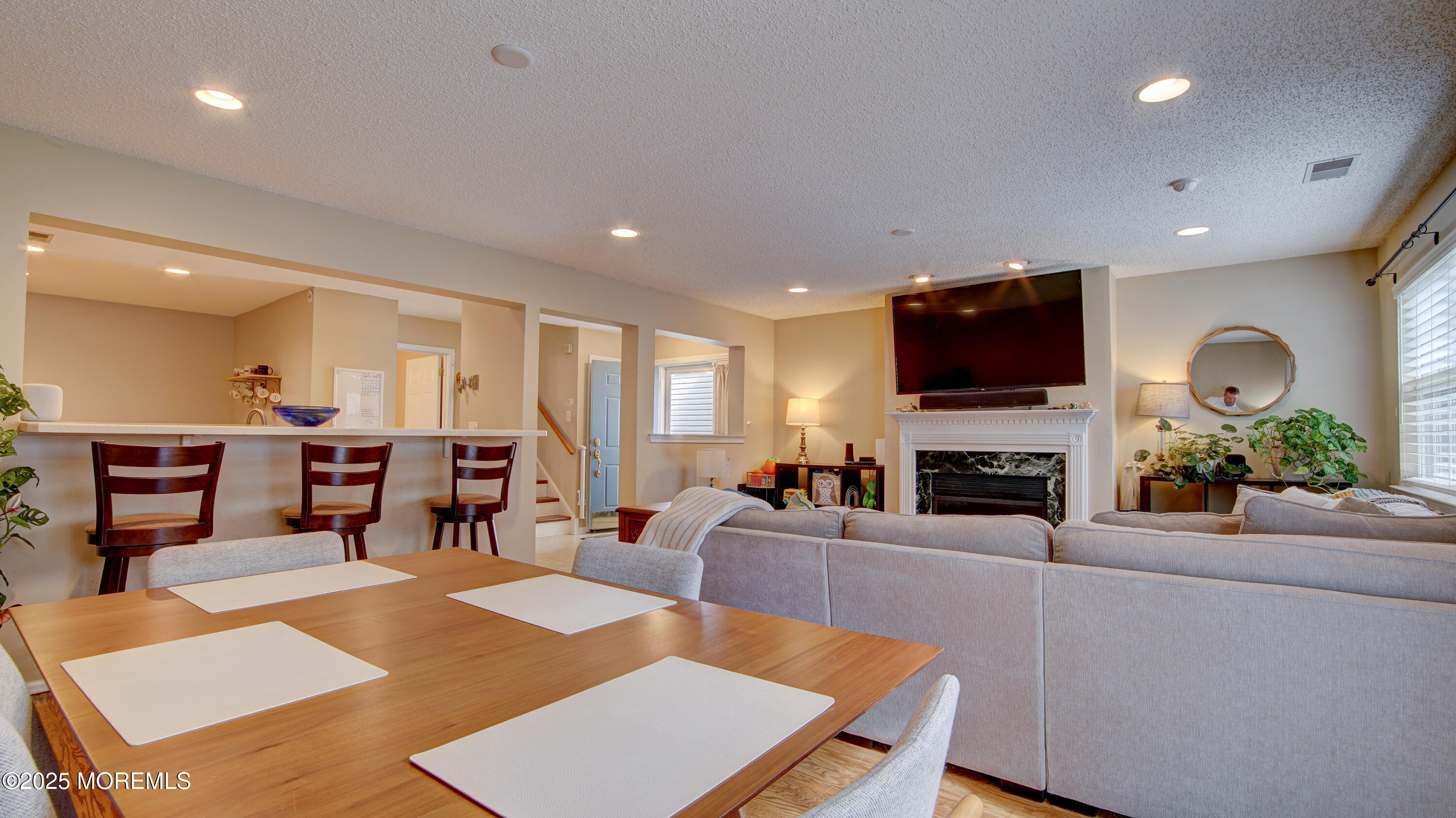 53 Winged Foot Court Howell, NJ 07731 - Photo 5 of 28 a living room with furniture a fireplace and a flat screen tv