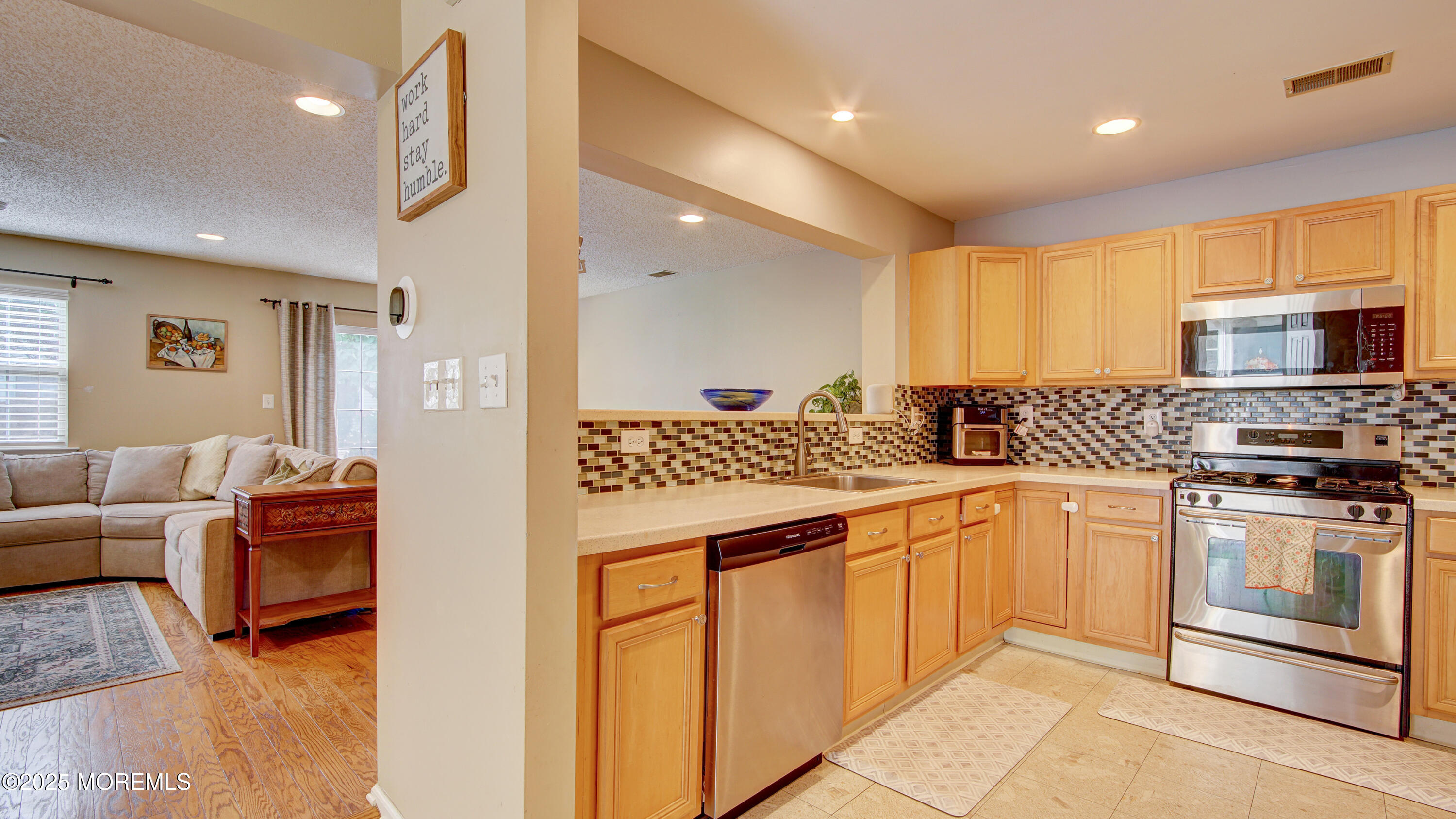 53 Winged Foot Court Howell, NJ 07731 - Photo 7 of 28 a kitchen with stainless steel appliances granite countertop a stove a sink and a refrigerator