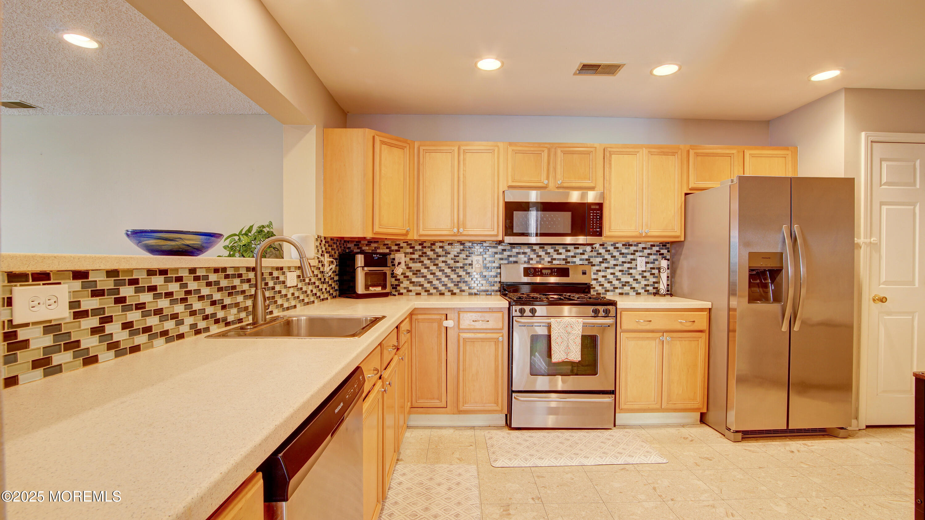 53 Winged Foot Court Howell, NJ 07731 - Photo 8 of 28 a kitchen with stainless steel appliances granite countertop a stove a sink and a refrigerator