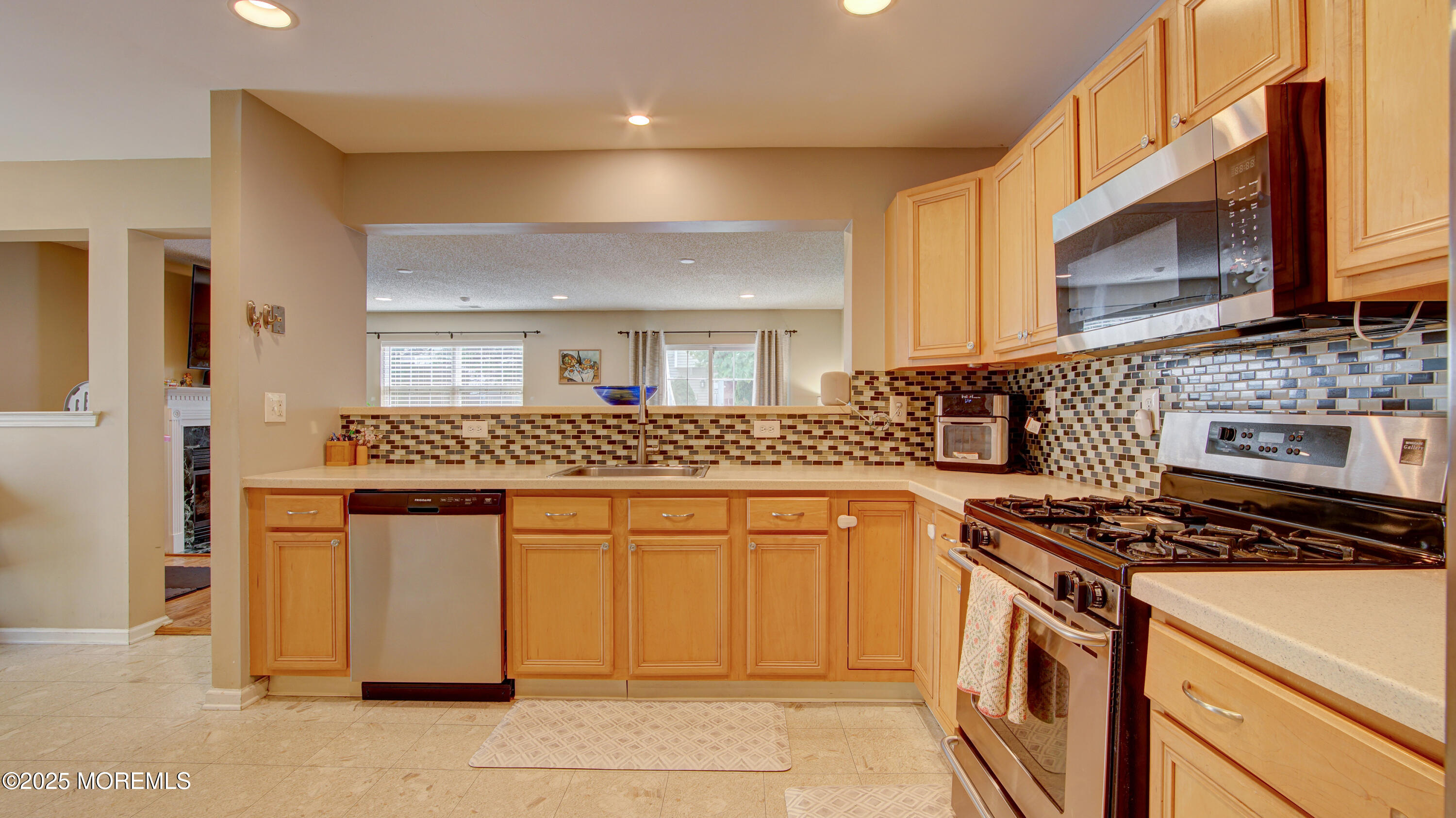 53 Winged Foot Court Howell, NJ 07731 - Photo 9 of 28 a kitchen with stainless steel appliances granite countertop a stove a sink and a microwave
