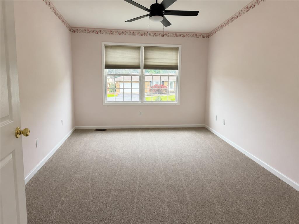 511 Howertown Road Northampton, PA 18067 - Photo 13 of 34 A well-lit bedroom features plush carpeting and a convenient ceiling fan for comfort.