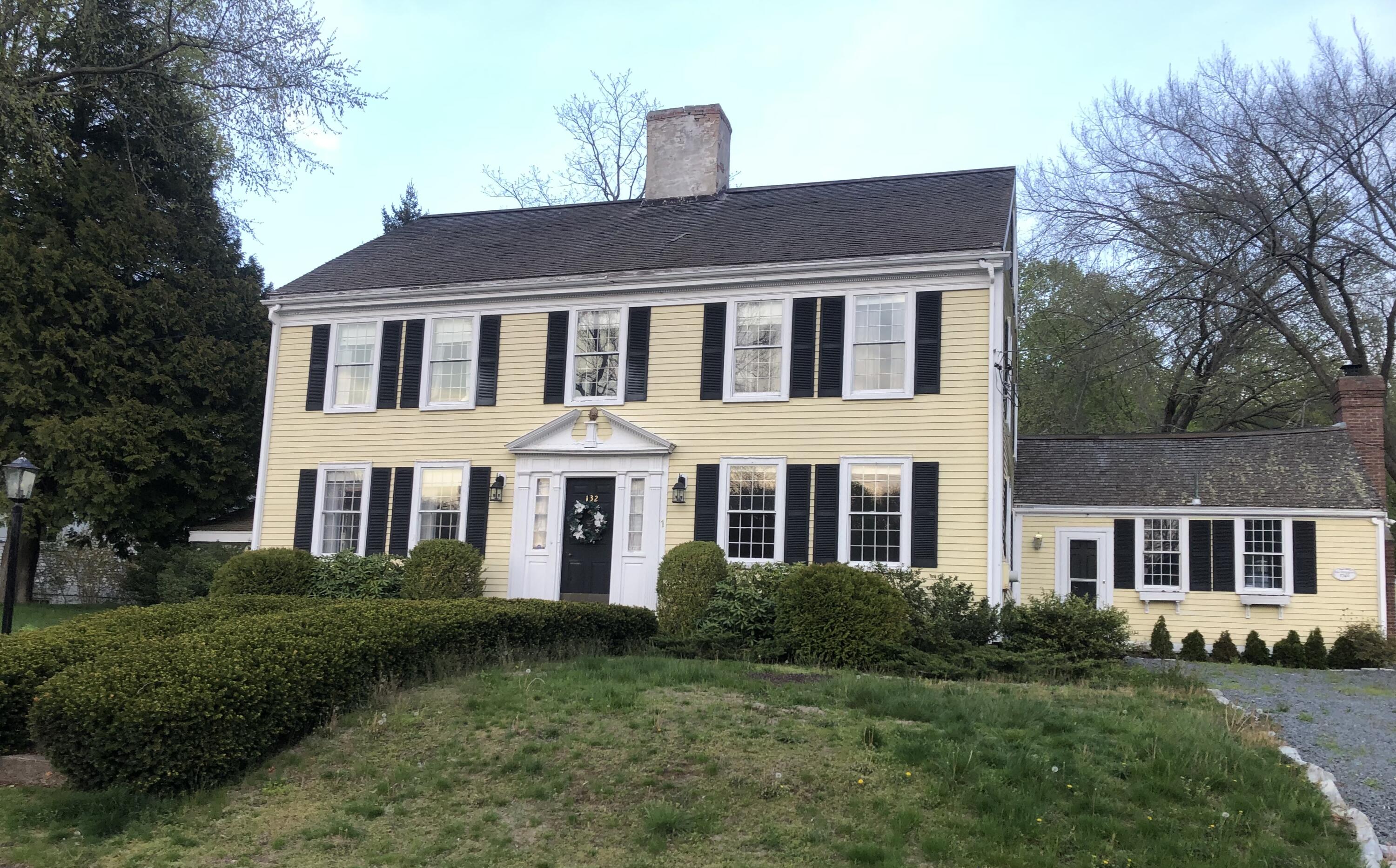 a front view of a house with a garden