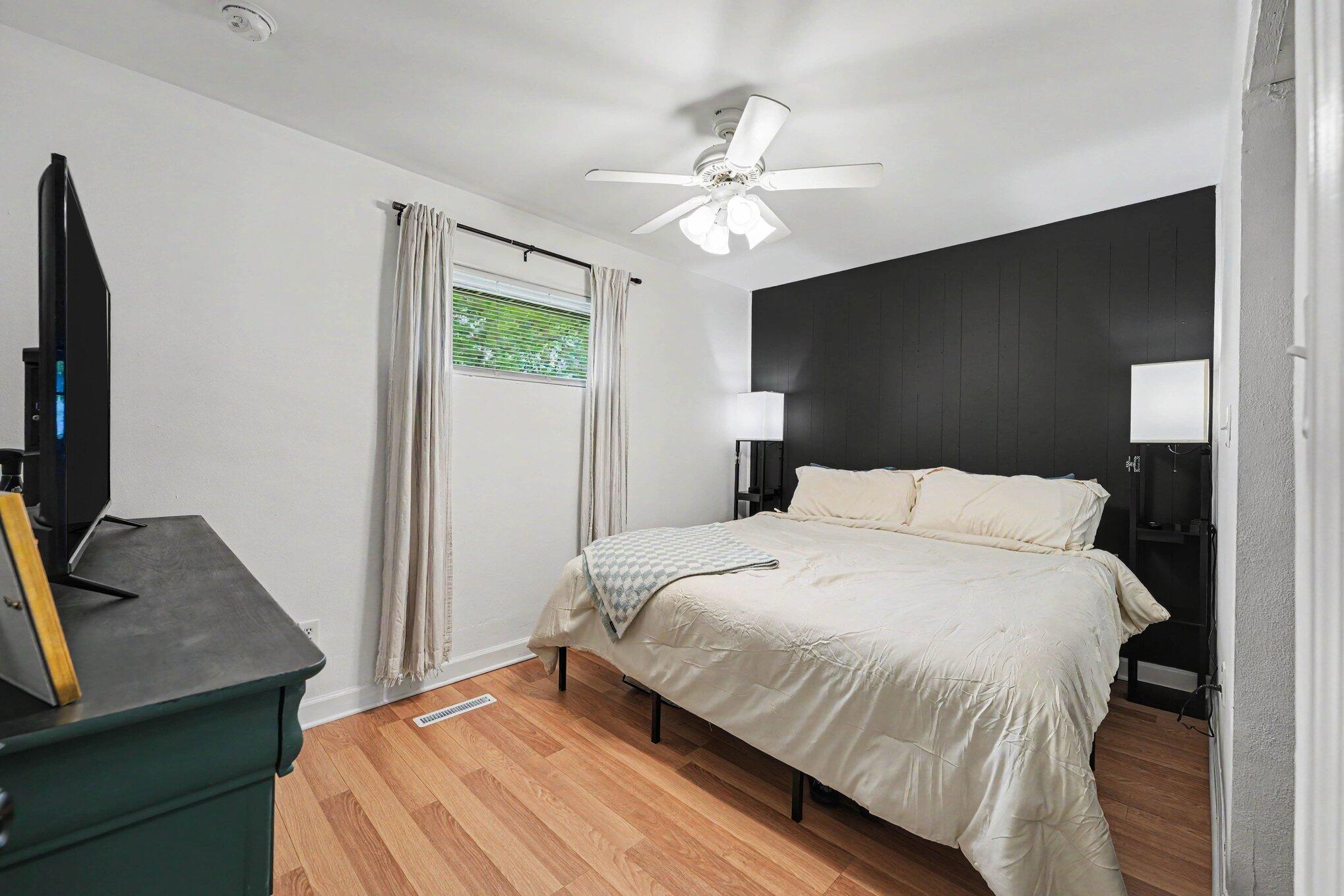 835 North Indiana Street Griffith, IN 46319 - Photo 13 of 19 a bedroom with a bed and a flat screen tv