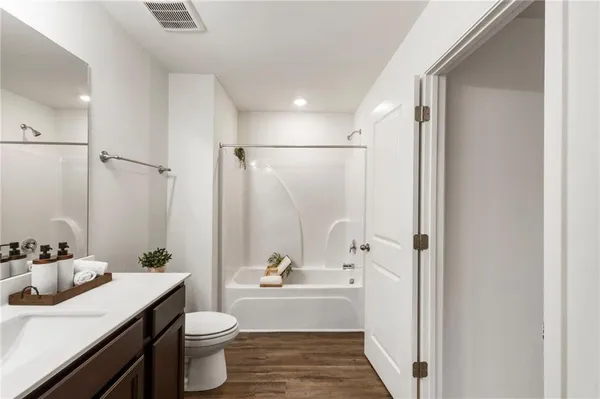 a bathroom with a double vanity sink toilet and shower