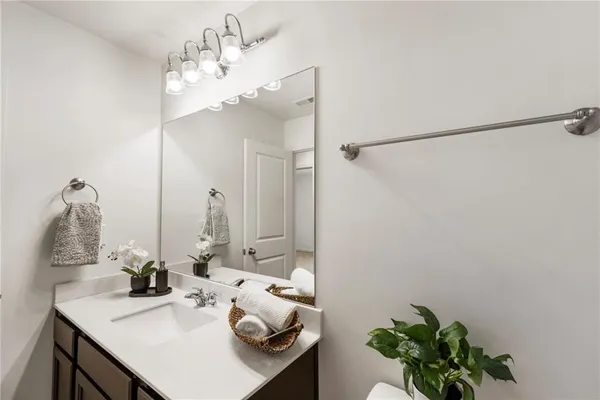 a bathroom with a sink vanity and a mirror