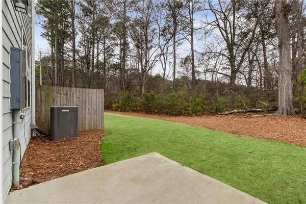 a view of backyard with large trees