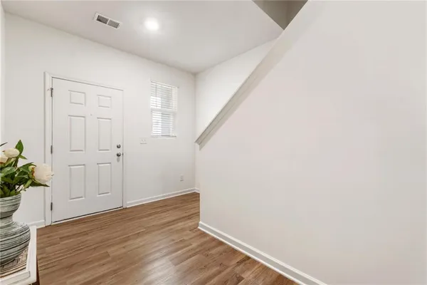 a view of an empty room with wooden floor
