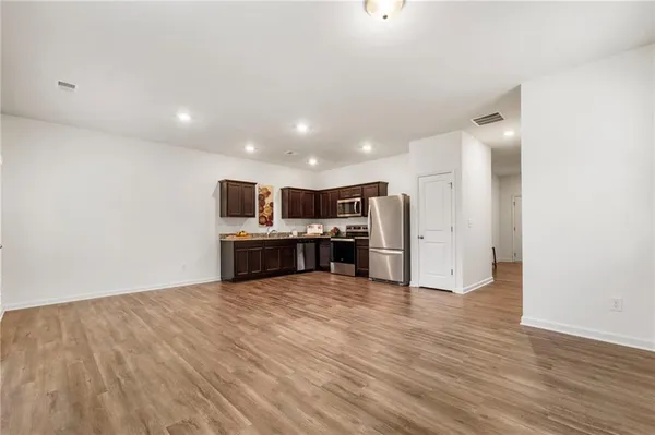 a view of kitchen with stainless steel appliances a refrigerator and a microwave