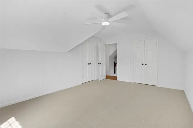 a view of an empty room with a ceiling fan