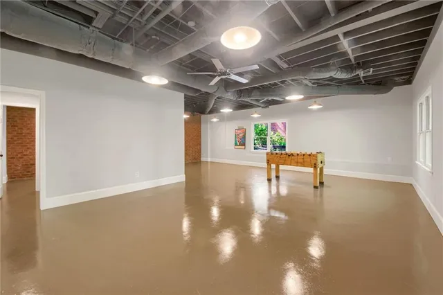 a room with lots of wooden furniture and a chandelier
