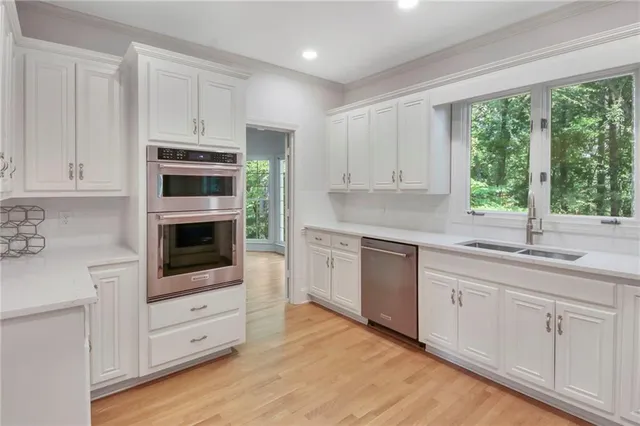 a kitchen with stainless steel appliances granite countertop a stove a sink and a microwave