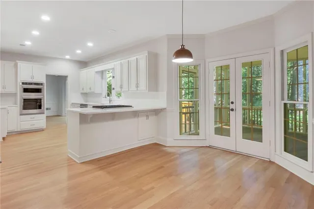 a view of a kitchen with a sink and dishwasher cabinets