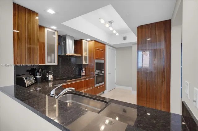 a spacious bedroom with a bed and a flat screen tv