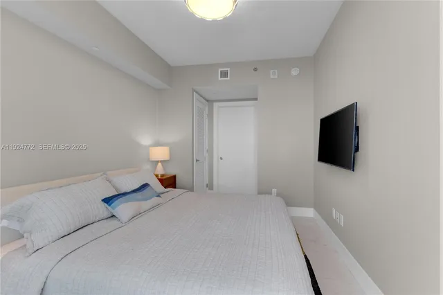 a living room filled with furniture and large windows