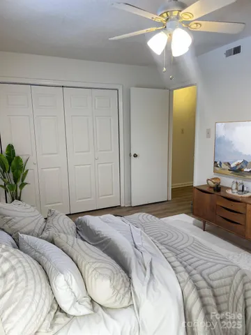 a bedroom with a bed and a chandelier