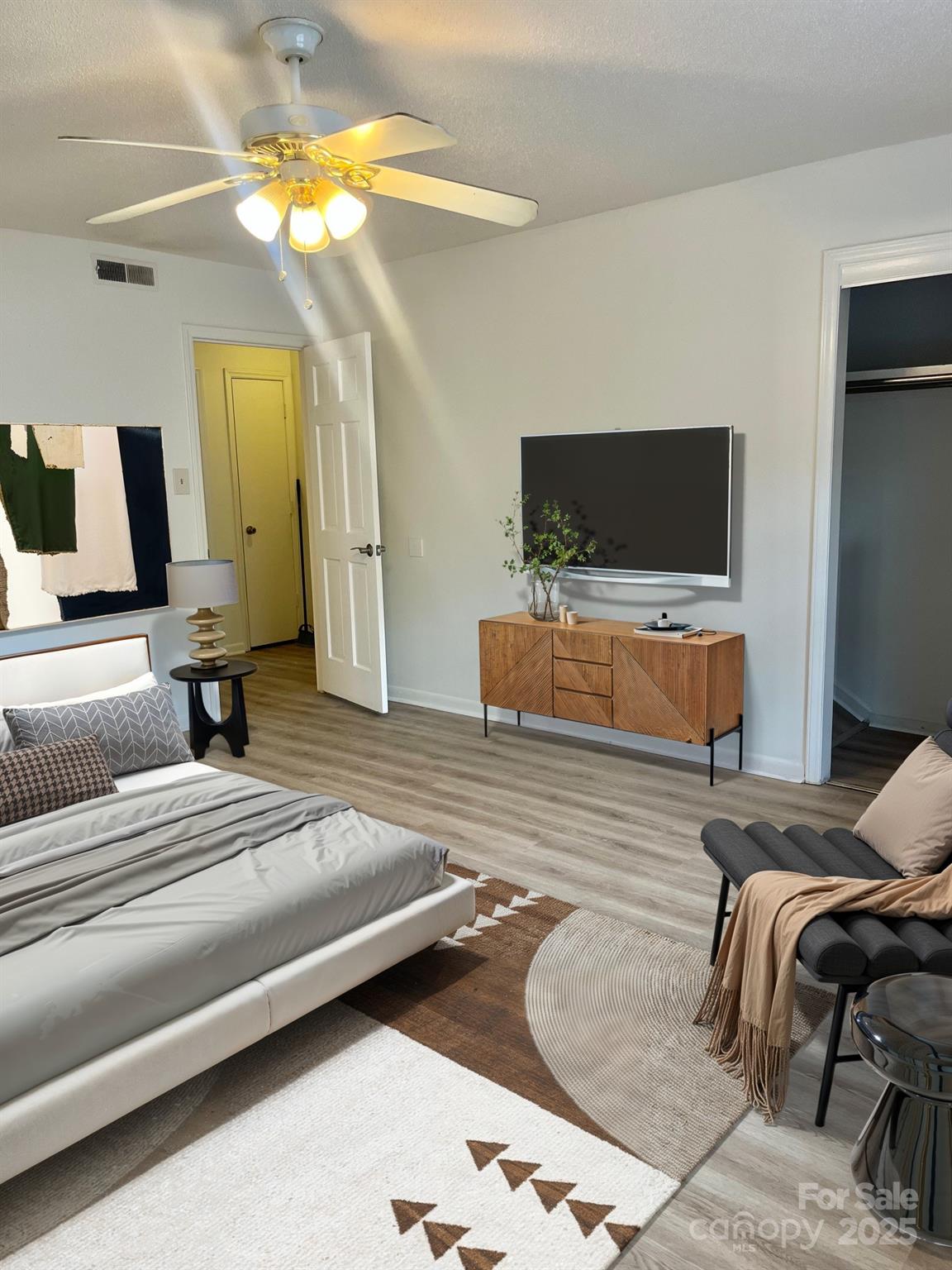 4520 Central Avenue, Unit C Charlotte, NC 28205 - Photo 9 of 18 a bedroom with a bed and a flat screen tv