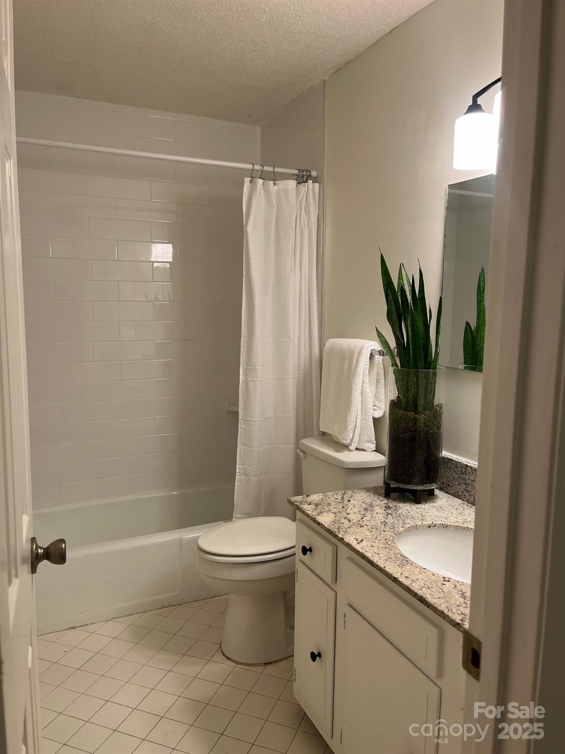 4520 Central Avenue, Unit C Charlotte, NC 28205 - Photo 10 of 18 a bathroom with a granite countertop sink a toilet and shower