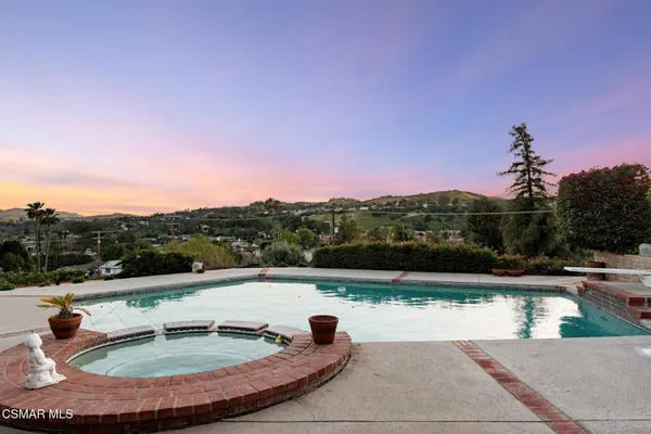 a view of swimming pool with outdoor seating and plants