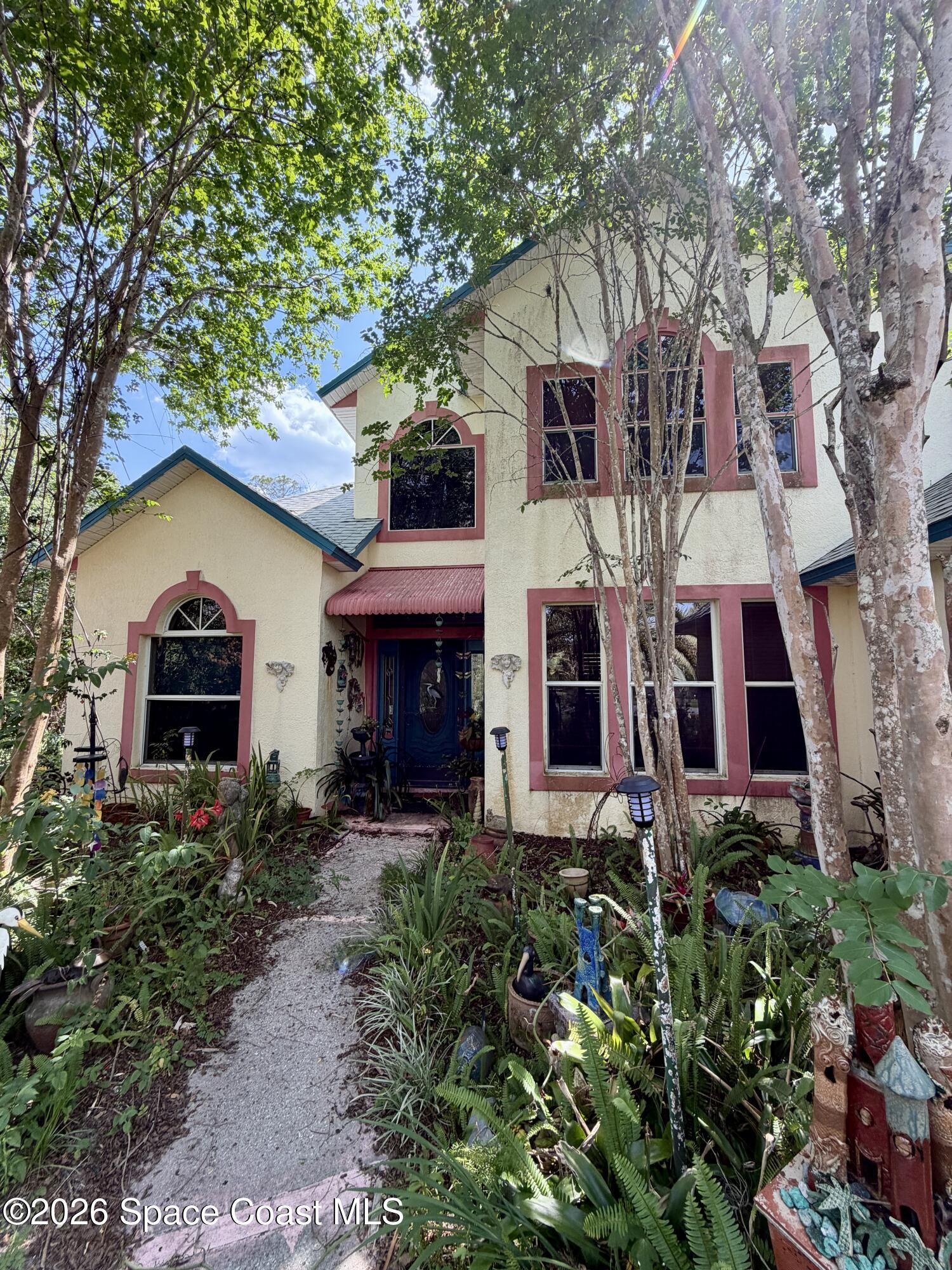 3535 Sparrow Hawk Trail Mims, FL 32754 - Photo 1 of 2 a front view of a house with yard and trees