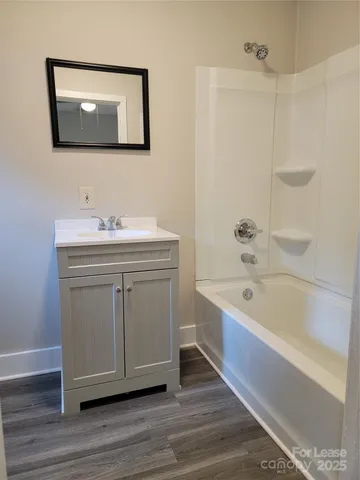 a bathroom with a bathtub a sink and a mirror