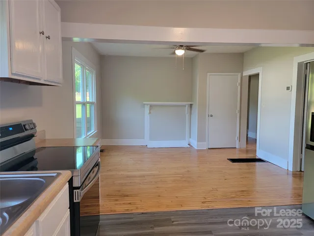 a kitchen with granite countertop a sink and a stove top oven