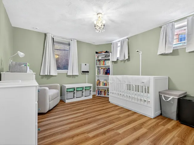 a bedroom with furniture and a wooden floor