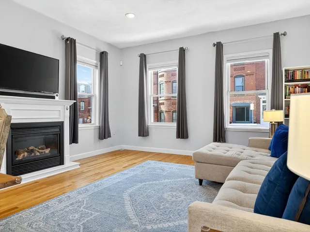 a living room with furniture fireplace and flat screen tv