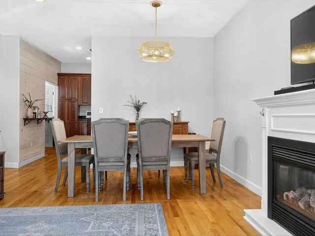 a view of a a dining room with furniture window and wooden floor