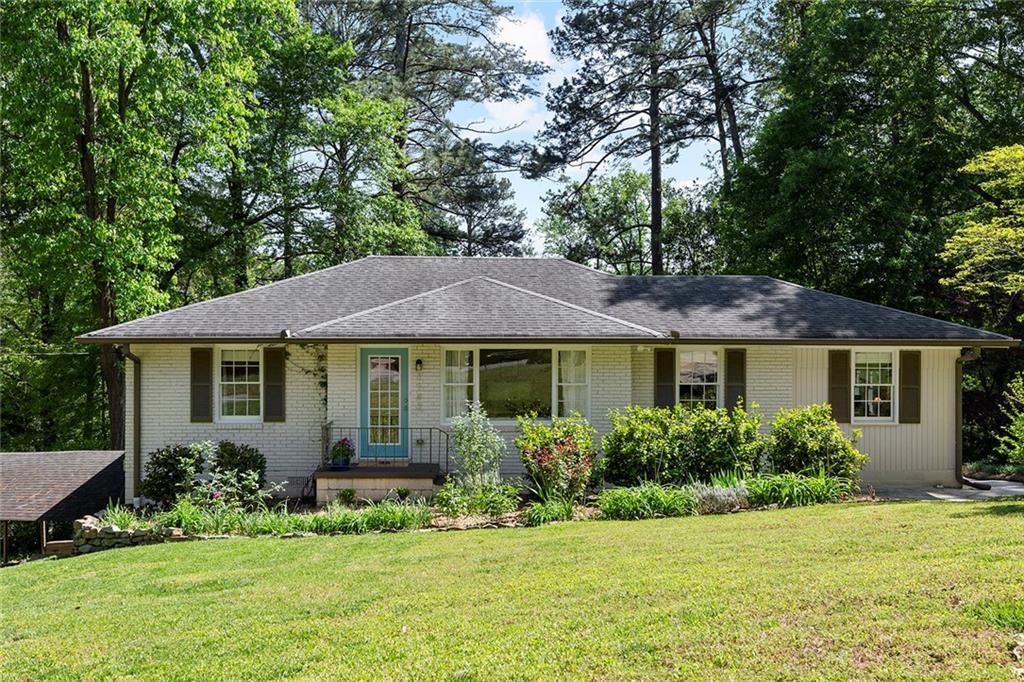 a front view of a house with a garden