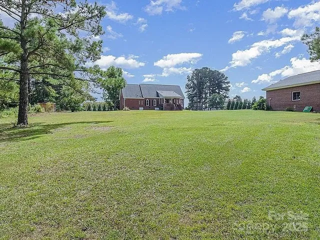 a view of a big yard with a house