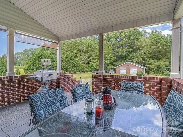 a view of a patio with a dining table and chairs