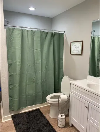 a bathroom with a toilet and a shower