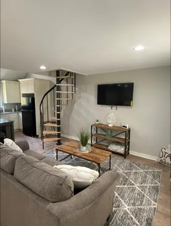 a living room with furniture and a flat screen tv