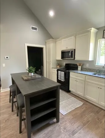 a kitchen with a sink cabinets and microwave