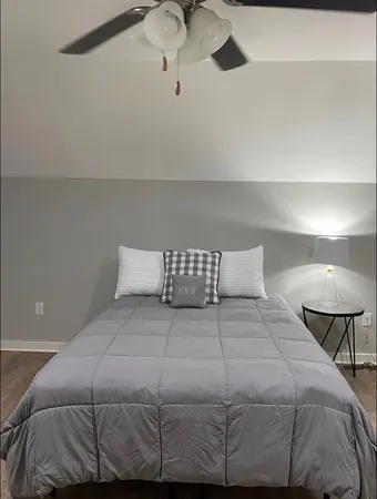 a bedroom with a bed and a lamp