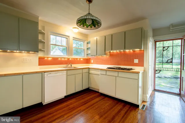 a kitchen with granite countertop cabinets and window