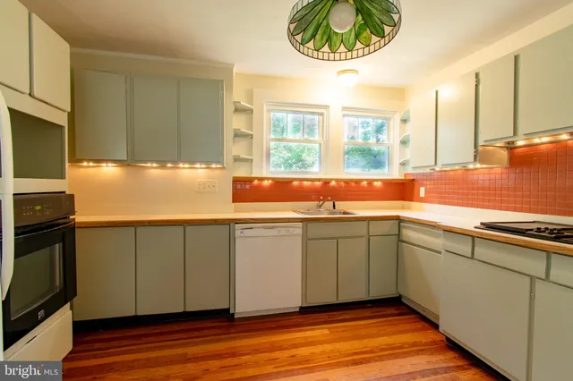 a kitchen with stainless steel appliances granite countertop a sink and a microwave