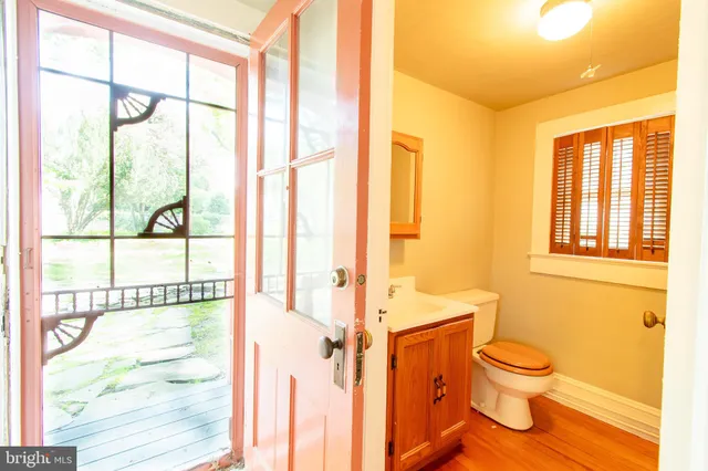 a bathroom with a toilet sink and a large window