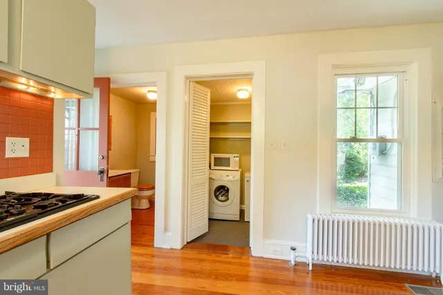 a view of a livingroom with wooden floor and a window