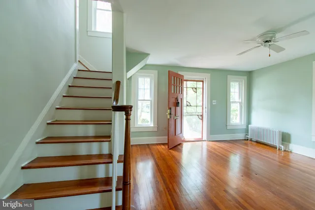a view of entryway with wooden floor and stairs