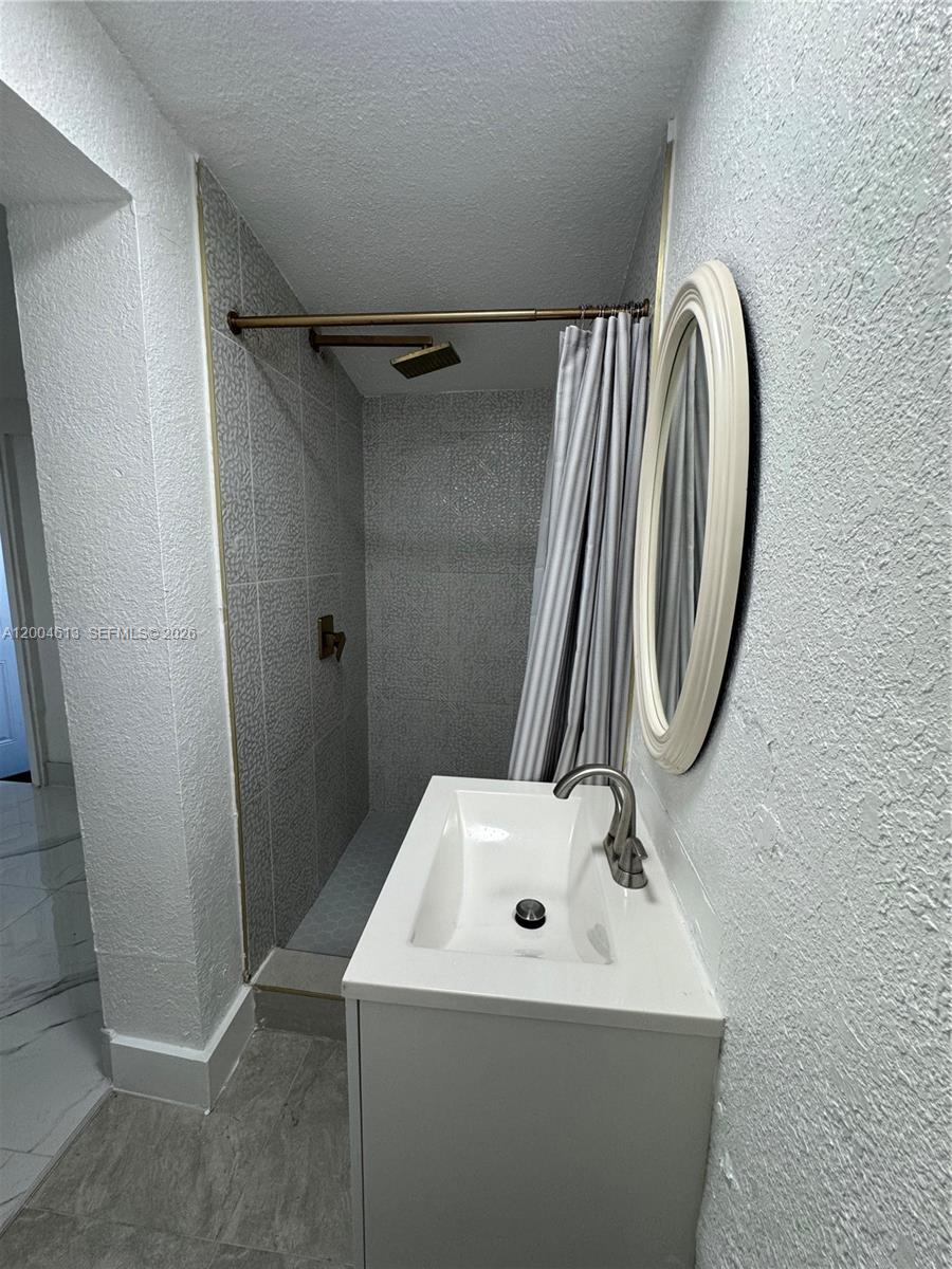 2796 Southwest 34th Court Miami, FL 33133 - Photo 4 of 8 a bathroom with a sink and a mirror